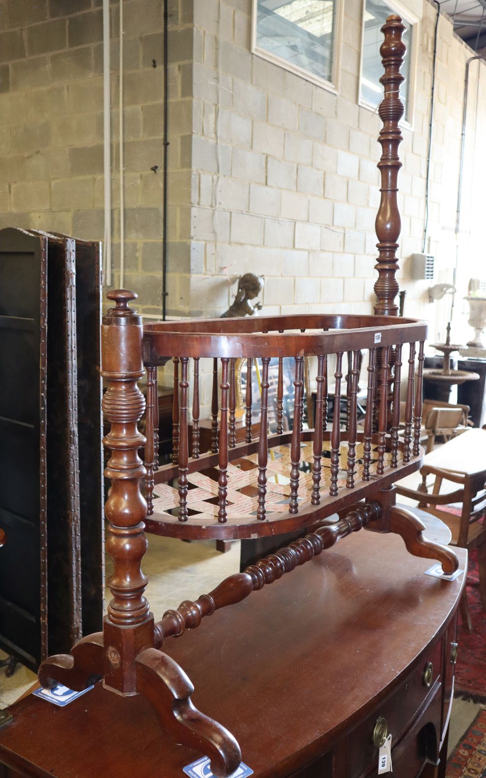 A 19th century French mahogany spindle cradle, W.116cm, D.50cm, H.160cm